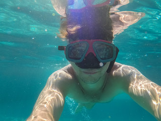 Fototapeta premium The man with the underwater mask is engaged in diving