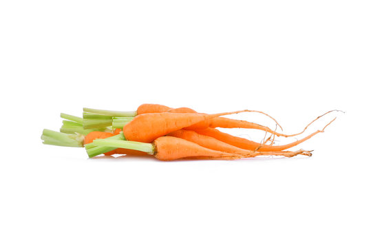 Pile Of Baby Carrots With Root Isolated On White Background