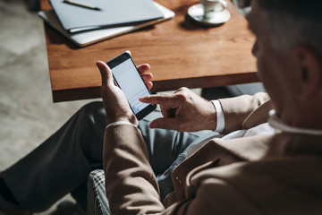 Fototapeta premium Businessman Typing on Cell Phone
