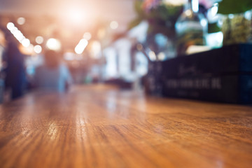 Image of wooden table and abstract blurred background of restaurant, place for your design