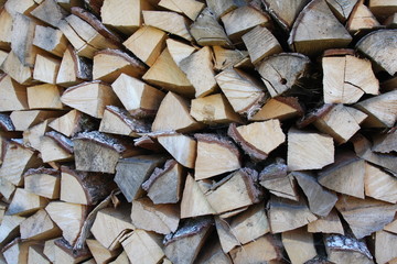 Chopped and stacked country village pile of birch wood. Texture, background