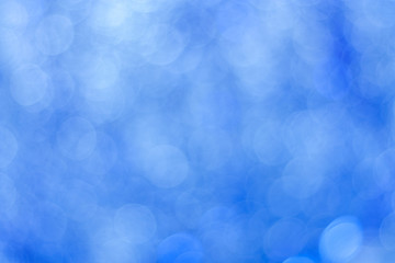 Abstract blue bokeh background. Circle lights of blurred tinsel.