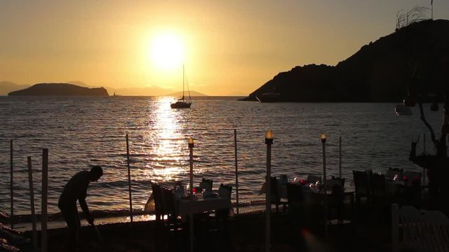 A view a beach side restaurant as the sun sets over the Greek island of Kalymnos.