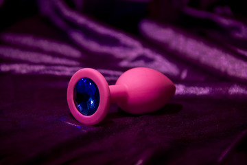 Silicone dildo anal Sex toy on a purplr background.
