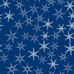 Seamless pattern with abstract colorful snowflakes on blue background. Chaotic, random, scattered winter motives. Vector illustration.