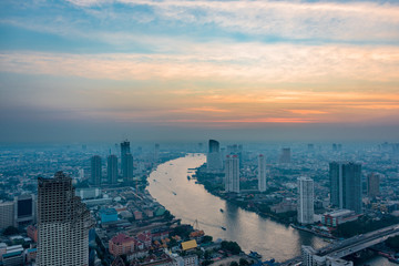 Naklejka na ściany i meble Aerial view of Bangkok cityscape with Chao Phraya river at sunset