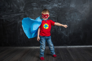 boy superhero in a blue Cape red mask and a red t-shirt with a star