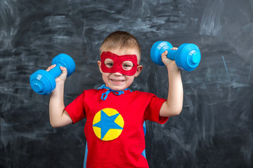 boy superhero with dumbbells © Sonya