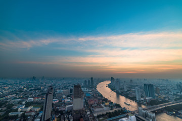 Aerial view of Bangkok cityscape with Chao Phraya river at sunset