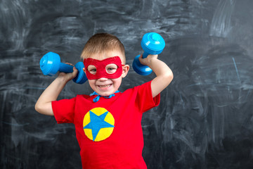 boy superhero with dumbbells