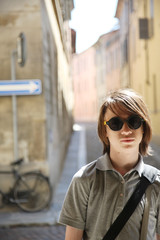 Fototapeta premium Portrait of a teenager in sunglasses on a city street