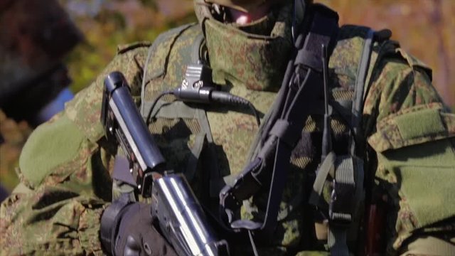 Soldier near old rusty AAA gun. Search and destroy operation.