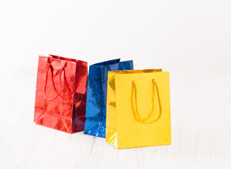 Yellow, red and blue gift bags on white background
