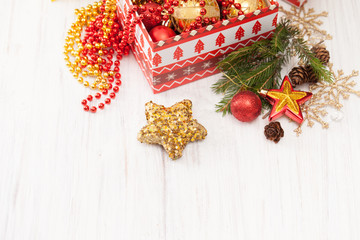 Part gift box with Christmas balls and decorations on white background