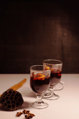 glasses for mulled wine, Hot Holiday mulled wine, winter hot drink, warming, New Year's background, mulled wine against a background of dried flowers, cotton, spruce branches