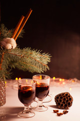 glasses for mulled wine, Hot Holiday mulled wine, winter hot drink, warming, New Year's background, mulled wine against a background of dried flowers, cotton, spruce branches
