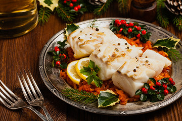 Christmas fish. Roasted cod pieces, served in vegetable sauce.