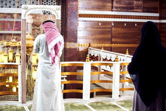 Two religious young people praying inside the mosque