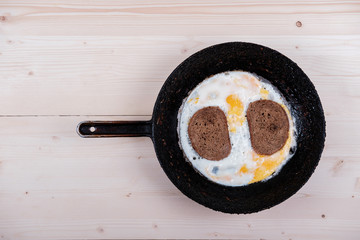 scrambled eggs with bread in the old cast iron skillet