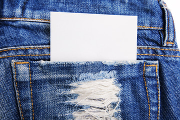 A piece of paper in the pocket of jeans trousers.