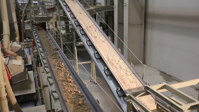 Сonveyor belt on factory, Ceramic factory equipment, Transportation of clay on the conveyor, industrial interior, Transportation of raw materials on the conveyor