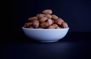 Peanuts in a white plate on the table