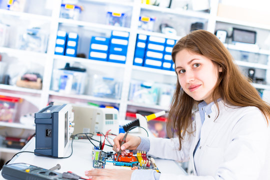 Young woman in electronics repair service center