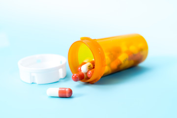 white pills in a yellow plastic bottle