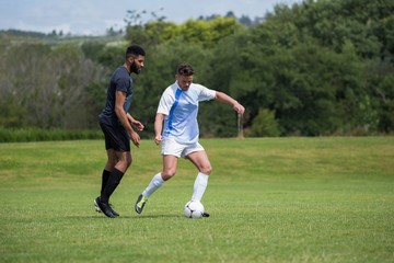 Obraz premium Football players playing soccer in the ground