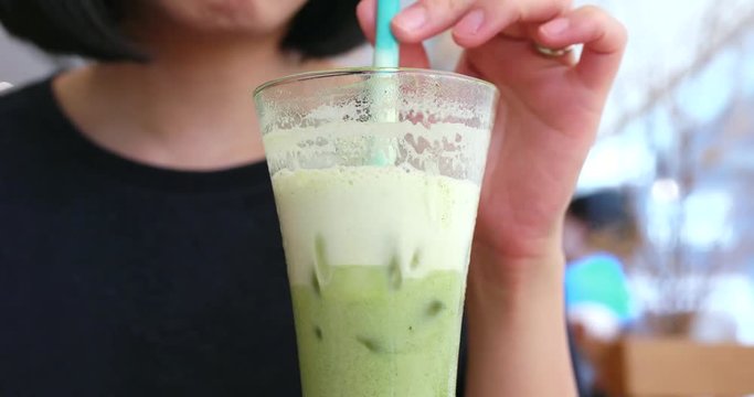 Woman enjoy green tea latte