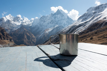 Cup on Table with Himalayas in the Background