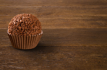 Traditional Brazilian brigadeiro on wood background