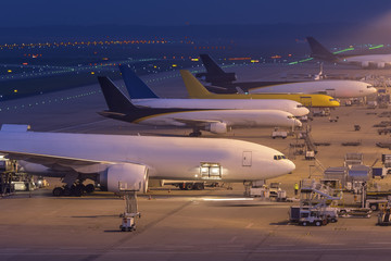 cargo airplanes at an airport at night