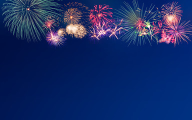 Fireworks on blue twilight background with copy space for text insertion on new year or special event celebration