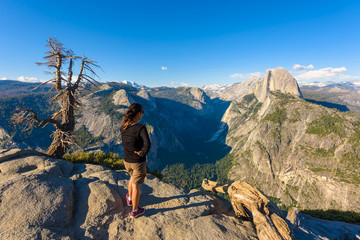 Hiker at the Glacier Point with View to Yosemite Valley and Half Dome in the Yosemite National Park, California, USA