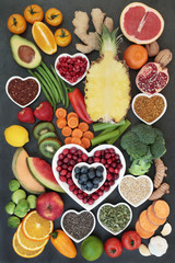 Health food for healthy eating concept with fruit, vegetables, seeds, nuts, tea, pollen grain,...
