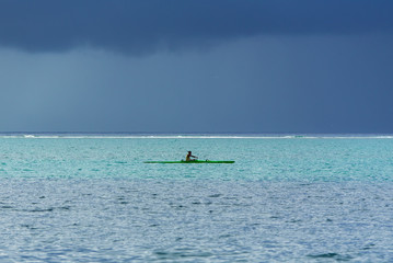 Polynesia, Moorea, panorama of the lagoon with a Polynesian which trains for the race of kayaks
