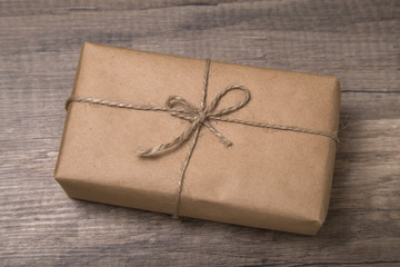 Christmas or New Year gift box wrapped in kraft paper with blank gift tag.