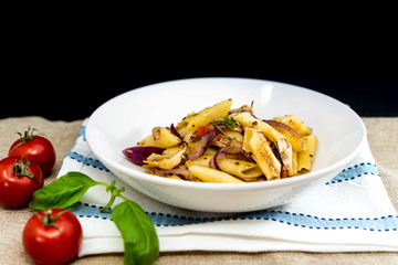Pasta with pesto sauce and nuts on a the table