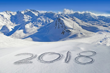 2018 written in the snow, mountain landscape in the background