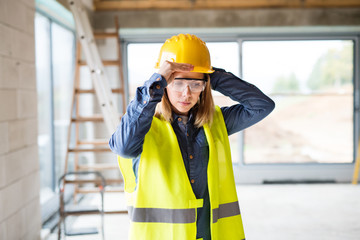 Young woman worker on the construction site.