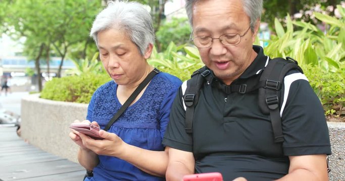 Asian elderly couple use of cellphone together