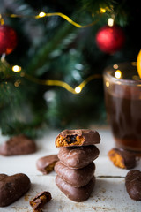 Gingerbread covered in chocolate on Christmas tree background