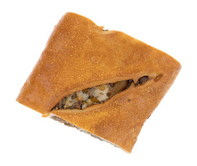 Top view of a slice of baked steak stromboli isolated on a white background.