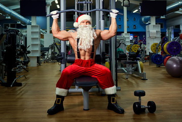 Santa Claus Bodybuilder training at the gym on Christmas Day.
