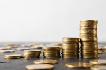 Increasing columns of gold coins on table