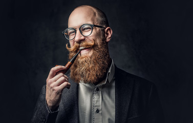 A man smoking pipe over grey background.