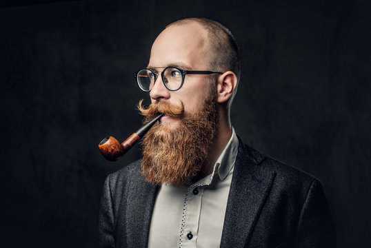 A man smoking pipe over grey background.