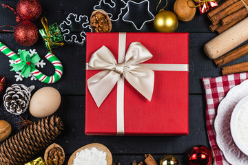 Christmas background with decorations and gift boxes on wooden board