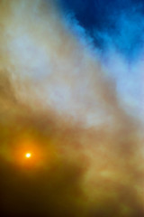 Cloudscape sky with smoke from fire.